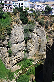 View on ancient village Ronda located precariously close to the edge of a cliff in Andalusia, Spain