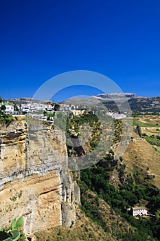 View on ancient village Ronda located precariously close to the edge of a cliff in Andalusia, Spain