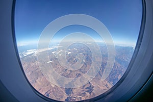 View of the Andes mountains covered with a little bit of snow, taken from an airplane on the way to Santiago, Chile