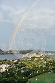 View of the Aragonese castle of Baia with rainbow