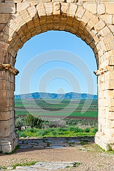 A View Through the Arch of Caracalla at the Roman Ruins of Volubilis in Morocco