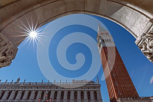 View from the arch of the Doge`s Palace Palazzo Ducale to the famous St. Mark`s Bell Tower Campanile di San Marco. Venice,