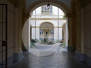 View through an arch of a formal courtyard