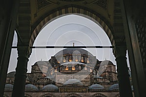view through arch on suleymaniye mosque in evening