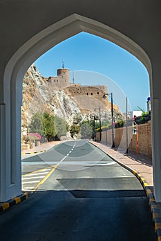 View from the arch to the Al Mirani castle on the rock standing on the rock, Muscat, Oman