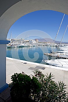 View through arch to Duquesa port and mountains