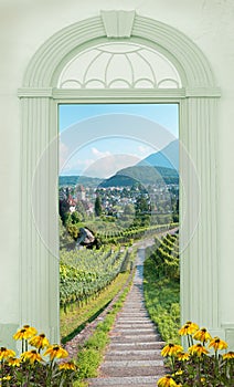 View through arched door, path through vineyard switzerland