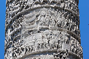 Architectural detail from ancient Marcus Aurelius Column in front of Palazzo Chigi in city of Rome, Italy