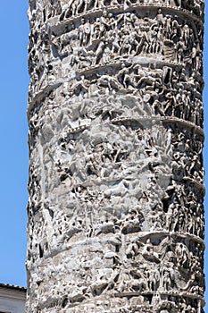 Architectural detail from ancient Marcus Aurelius Column in front of Palazzo Chigi in city of Rome, Italy