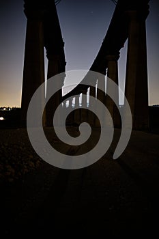 View of an Architectural structure with rocky columns at night with little light