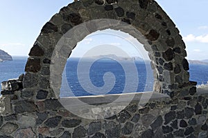 View through archway to aegean sea of santorini island