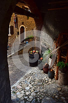 View through an archway in a typical italian small town. Frapporto, Tenno, Trentino, Italy