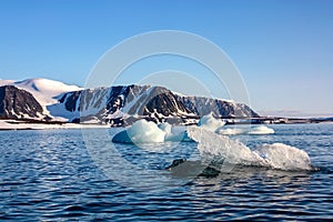 A view of the Arctic island from the sea, beyond the ocean,  the Arctic.