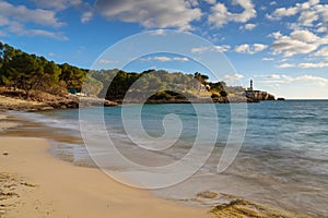 view of the Arenal dets Ases beach and the Portocolom Lighthouse in the background