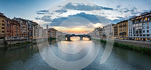 View of the Arno river, evening Florence and the St Trinity Bridge. Florence, Italy.