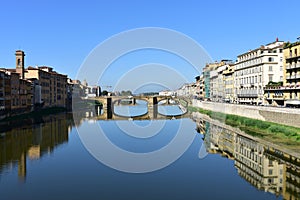 View of Arno river with Ponte Santa Trinita from Ponte Vecchio. Florence, Italy. The oldest elliptic arch bridge in the world.