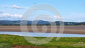 View of the arnside area from the bank of the river kent with surrounding lake district countryside