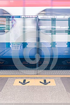 View of arrows sign on platform at Sky train station. - Split to