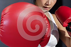 View of Asian Woman with Red Boxing Glove Punching to her Front Opponent