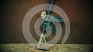 View of the assault rifle against the background of rusty steel