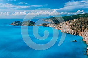 View of Assos village town and Frourio peninsular castle ruins on top. Beautiful milky blue bay with brown rocky