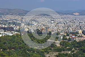 View of the Athens and the ancient Temple of Hephaestus, a doric greek temple in the north-west side of the Agora of Athens,