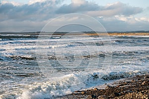View on Atlantic ocean, Strandhill beach, county Sligo Ireland. Strong waves and cloudy sky