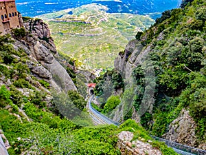 View atop the trainline platform above  Cathedral at Santa Maria de Montserrat abbey in Monistrol, Catalonia, Spain