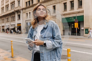 View of attractive caucasian woman loking away and smiling in the city