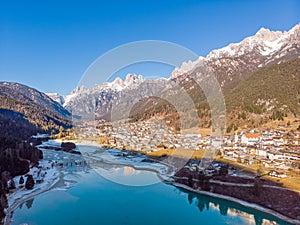 The view of Auronzo and the frozen lake Santa Katerina, Dolomites, Italy photo