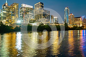 View of Austin, Texas in USA downtown skyline. Night golden sunset city. Reflection in water.