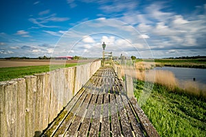 View on the authentic old harbor with wooden seawall and wooden Jetty, Schokland, Netehrands