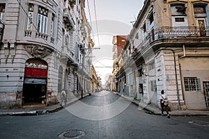 View of authentic street with old colonial buildings and local people at every day life. old part of Havana City