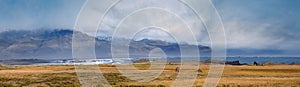 View during auto trip in Iceland. Spectacular Icelandic landscape with  scenic nature: mountains, ocean coast, fjords, fields,