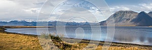 View during auto trip in Iceland. Spectacular Icelandic landscape with scenic nature: mountains, ocean coast, fjords, fields,