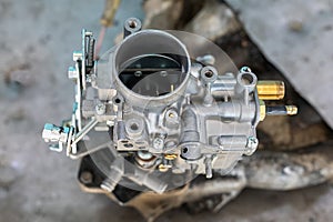 View of automobile carburetor. A carburetor (also spelled carburettor or carburetter)