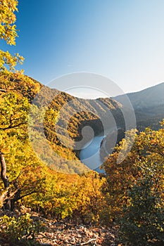 View of autumn scenery of Domasinsky meander in Zilina region, Slovakia. The Vah River flows past autumn forests in a U-shape