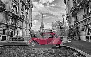 Eiffel Tower in Paris and red retro car in black and white color-key