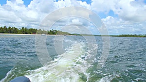 View from the back of a boat navigating slowly