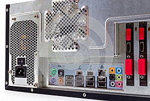 View from the back of a desktop computer with a visible connection panel, audio, LAN, mouse, keyboard, USB.