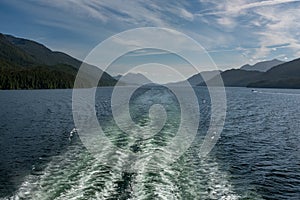 The view from the back of a ferry as it makes its way through the Inside Passage off the rugged west coast of Canada, the light