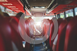 View from back seat in a bus. People sitting in a coach.