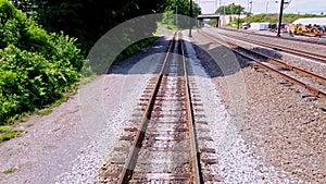 View From the Back of a Train as it Travels along Multiple Tracks