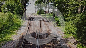 View From the Back of a Train as it Travels along Multiple Tracks