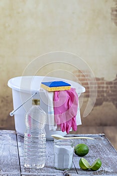 View of baking soda with ,white, bucket, mop, gloves, lemon, vinegar, glove, , natural mix,for effective house cleaning
