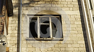 View of the balcony and a broken window after the fire in block of flats