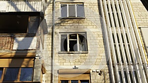 View of the balcony and a broken window after the fire in block of flats