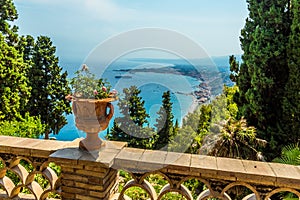A view from a balcony in the Garden of Villa Comunale over the shoreline of Taormina, Sicily