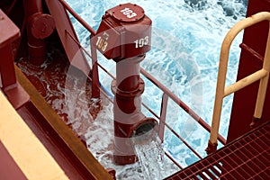 View of Ballast Water exchange process onboard of a ship using flow-through method underway in open ocean. Overflow method through