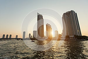 View of Bangkok from Chao Phraya river during sunset.